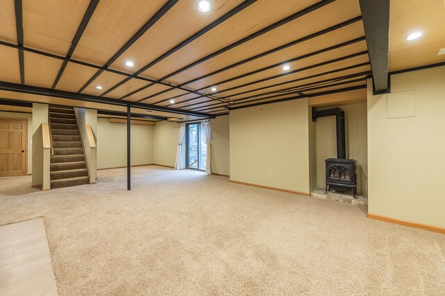 3329 Craig Rd, Ann Arbor, MI 48103 - basement with recessed lighting, carpet floors, stairway, a wood stove, and baseboards