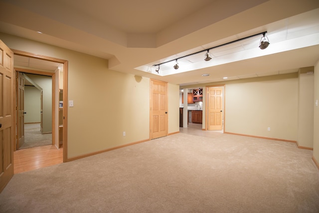 3329 Craig Rd, Ann Arbor, MI 48103 - unfurnished living room with light colored carpet, baseboards, and track lighting