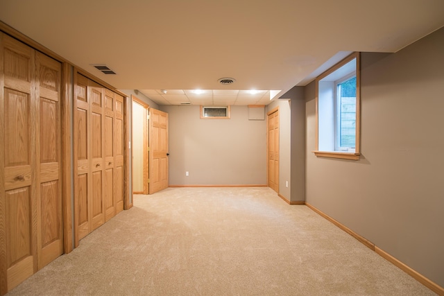 3329 Craig Rd, Ann Arbor, MI 48103 - basement with light carpet, baseboards, and a paneled ceiling