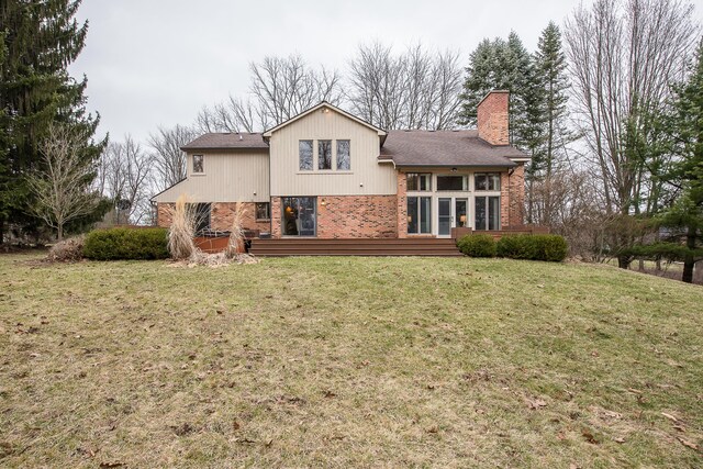 3329 Craig Rd, Ann Arbor, MI 48103 - rear view of property with brick siding, a chimney, a lawn, and roof with shingles