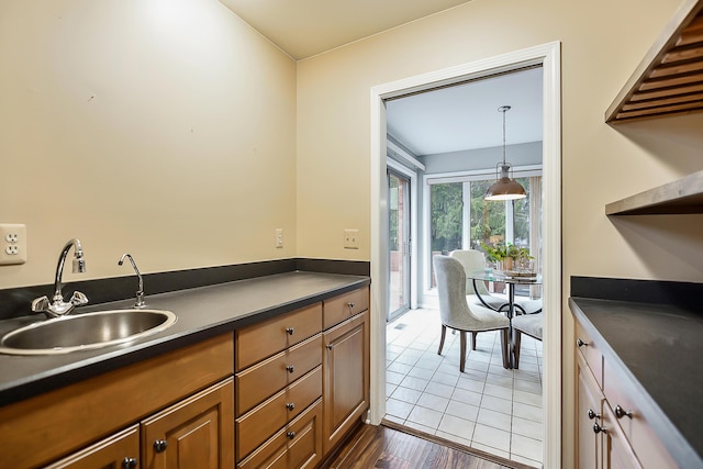 3329 Craig Rd, Ann Arbor, MI 48103 - kitchen with a sink, dark countertops, brown cabinetry, and open shelves