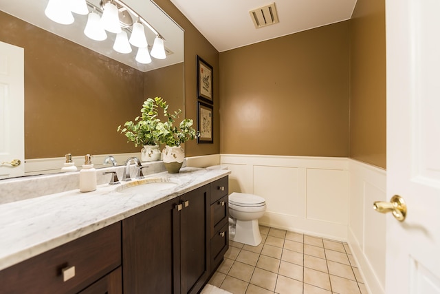 3329 Craig Rd, Ann Arbor, MI 48103 - bathroom featuring vanity, tile patterned flooring, a wainscoted wall, toilet, and a decorative wall