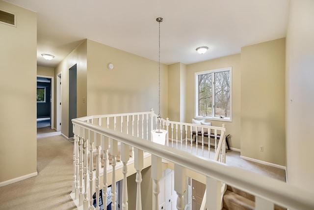 3329 Craig Rd, Ann Arbor, MI 48103 - hallway with carpet floors, baseboards, and an upstairs landing