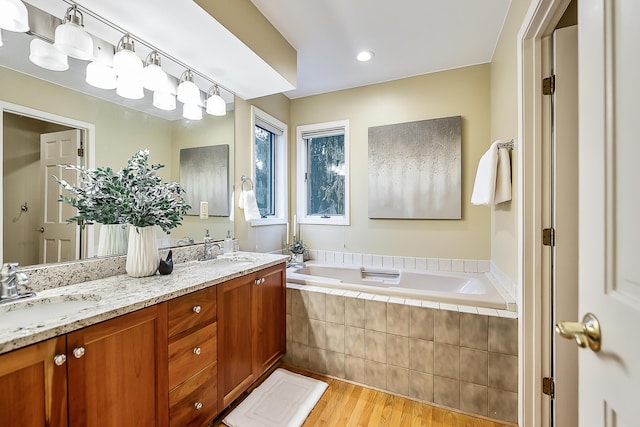 3329 Craig Rd, Ann Arbor, MI 48103 - bathroom with wood finished floors, a garden tub, double vanity, and recessed lighting