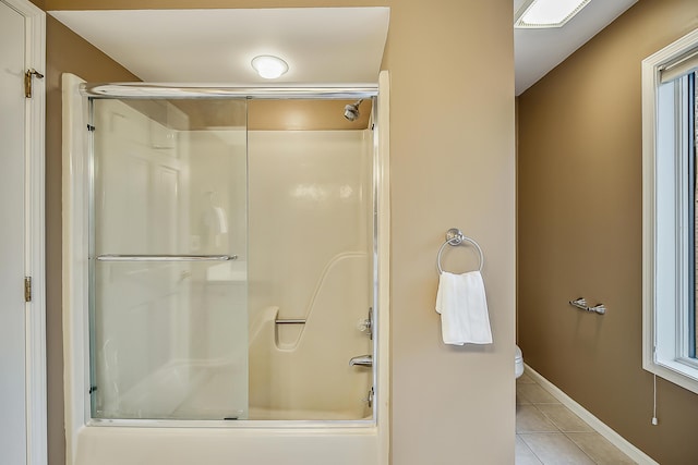 3329 Craig Rd, Ann Arbor, MI 48103 - bathroom with tile patterned floors, toilet, baseboards, and bath / shower combo with glass door