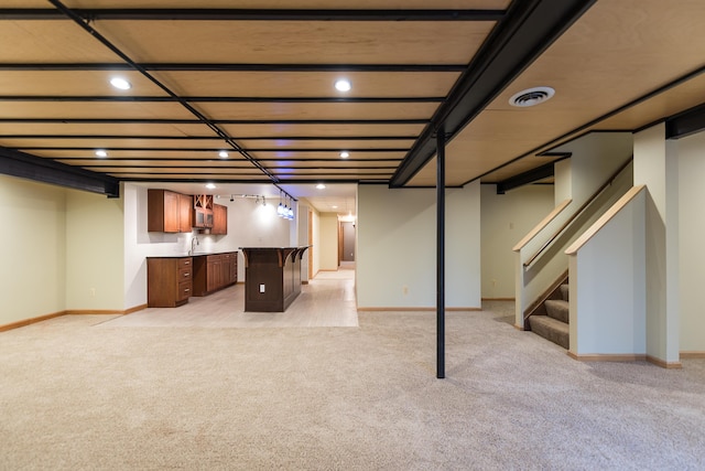 3329 Craig Rd, Ann Arbor, MI 48103 - finished below grade area featuring light colored carpet, stairs, bar, baseboards, and recessed lighting