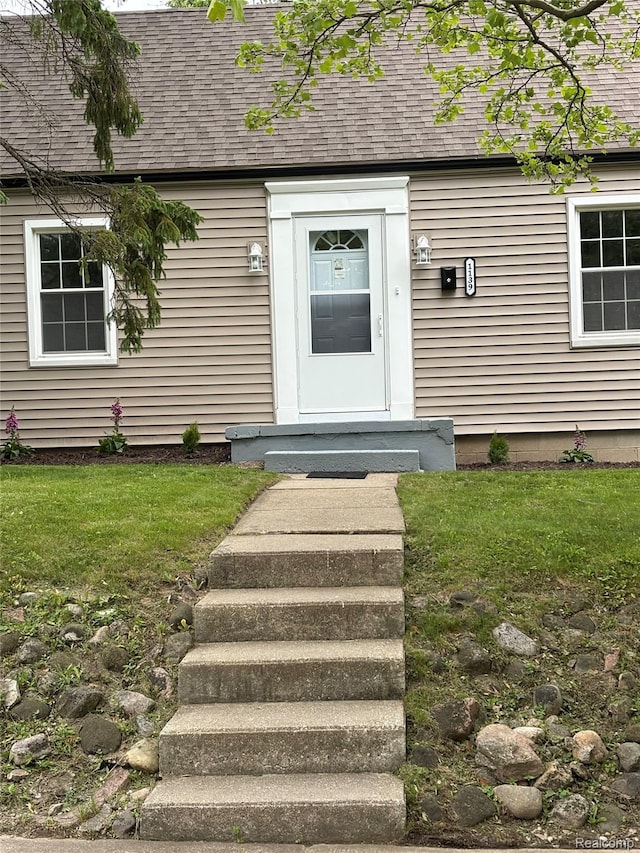 1139 S 7th St, Ann Arbor, MI 48103 - entrance to property featuring a shingled roof and a lawn