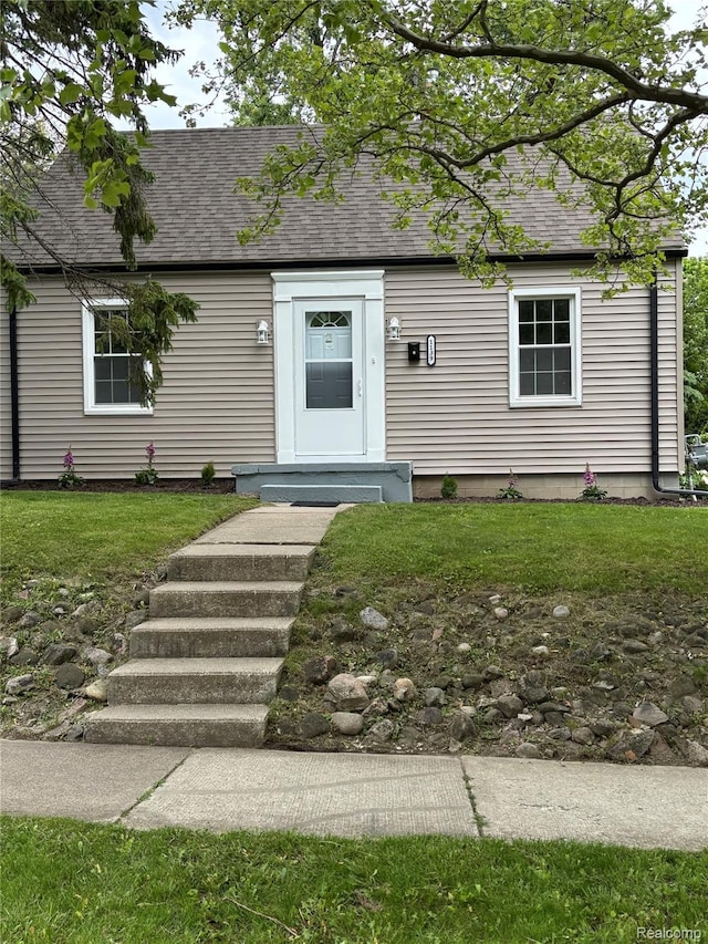1139 S 7th St, Ann Arbor, MI 48103 - view of front of home with a shingled roof and a front lawn