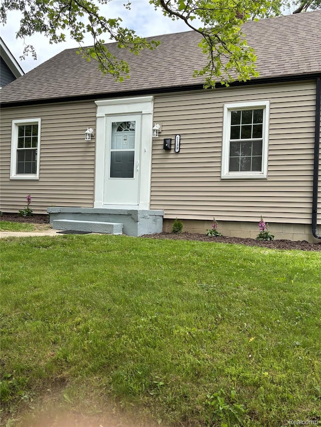 1139 S 7th St, Ann Arbor, MI 48103 - doorway to property featuring a lawn and roof with shingles