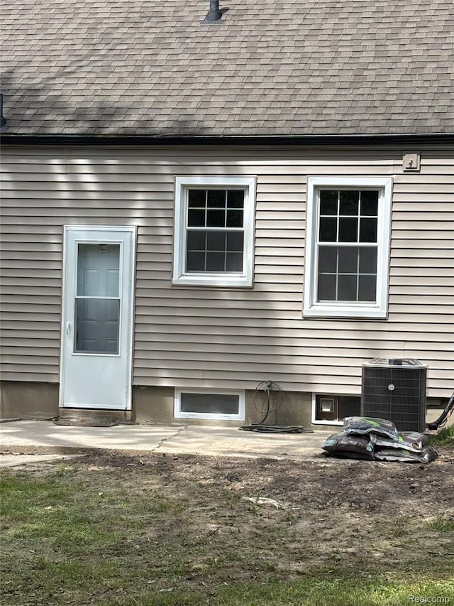1139 S 7th St, Ann Arbor, MI 48103 - view of home's exterior featuring roof with shingles and cooling unit