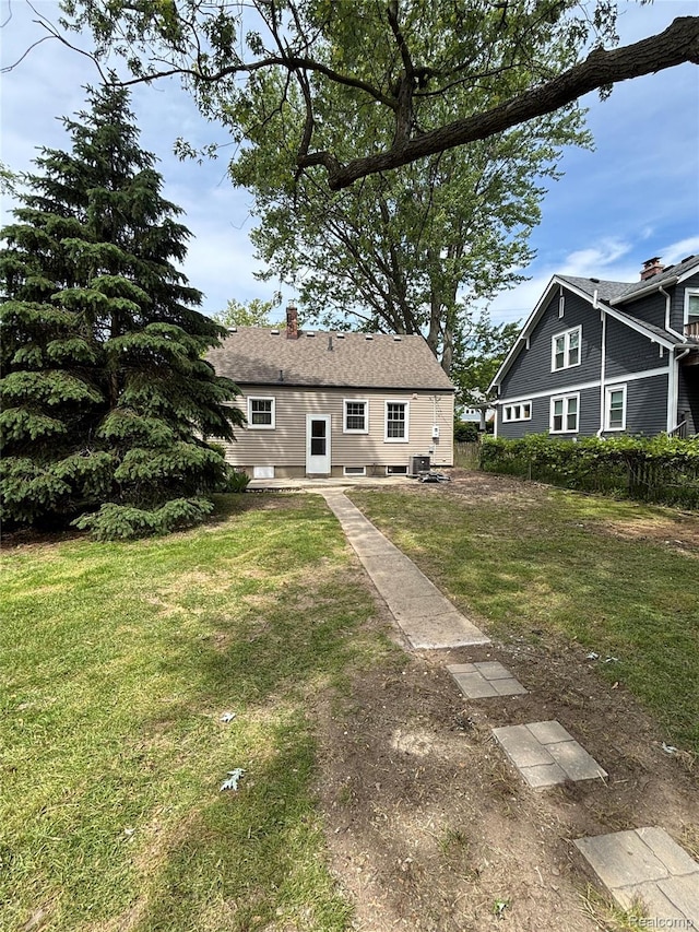 1139 S 7th St, Ann Arbor, MI 48103 - rear view of property featuring a yard and a chimney