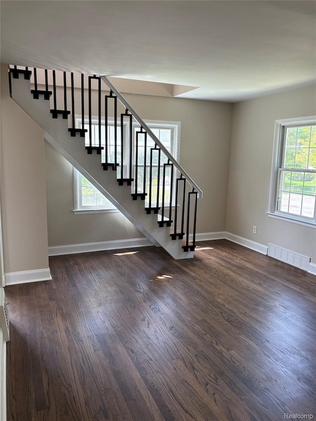 1139 S 7th St, Ann Arbor, MI 48103 - stairway with healthy amount of natural light, wood finished floors, and baseboards