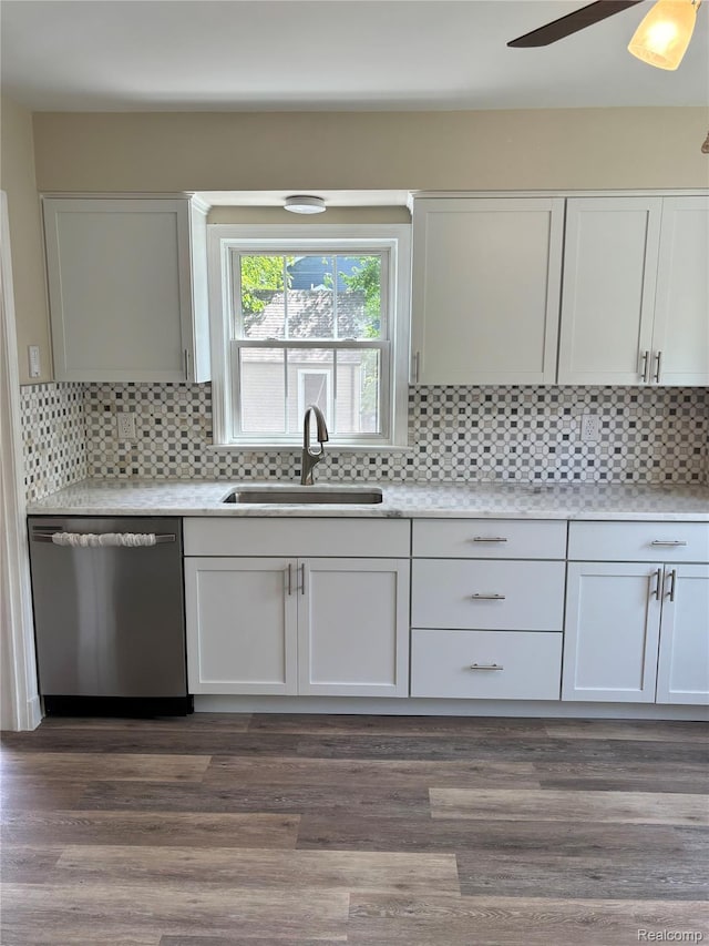 1139 S 7th St, Ann Arbor, MI 48103 - kitchen with dishwasher, a sink, ceiling fan, backsplash, and white cabinets