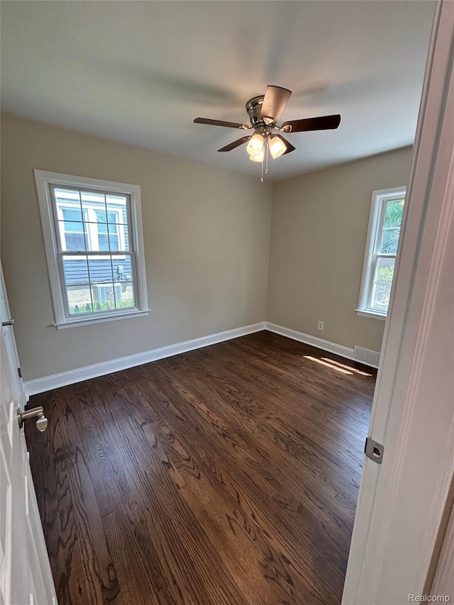 1139 S 7th St, Ann Arbor, MI 48103 - empty room featuring healthy amount of natural light, dark wood finished floors, and baseboards