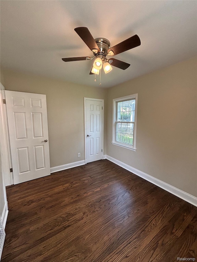 1139 S 7th St, Ann Arbor, MI 48103 - unfurnished bedroom with dark wood-type flooring, baseboards, and ceiling fan