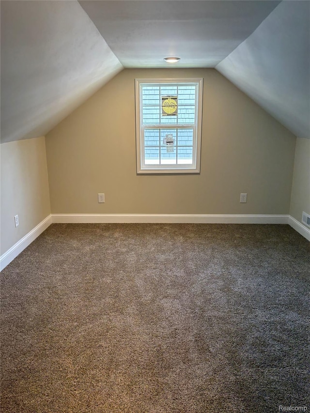 1139 S 7th St, Ann Arbor, MI 48103 - bonus room with vaulted ceiling, dark carpet, and baseboards