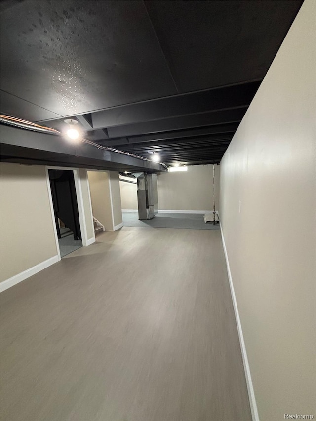 1139 S 7th St, Ann Arbor, MI 48103 - finished basement with baseboards, stairs, and wood finished floors