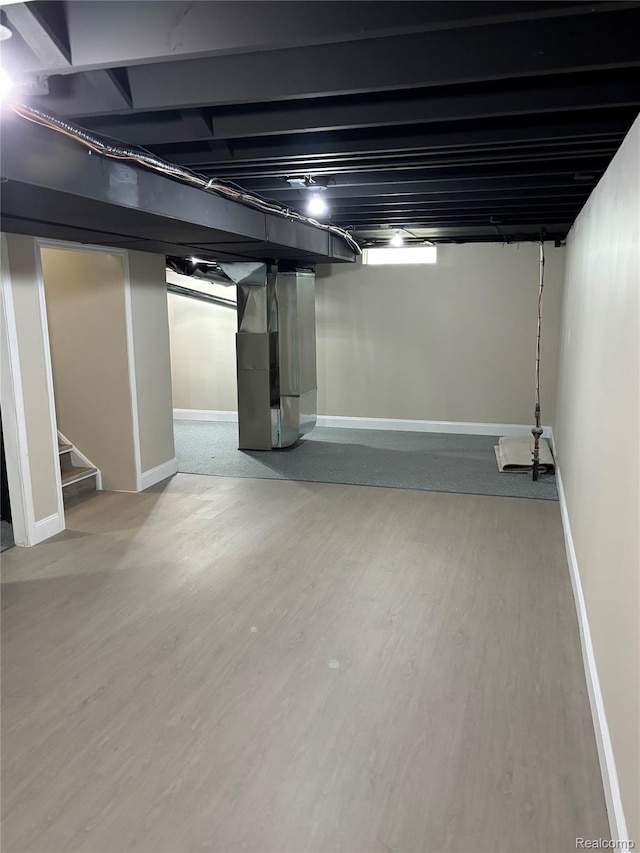 1139 S 7th St, Ann Arbor, MI 48103 - finished basement with wood finished floors, baseboards, stairway, and heating unit