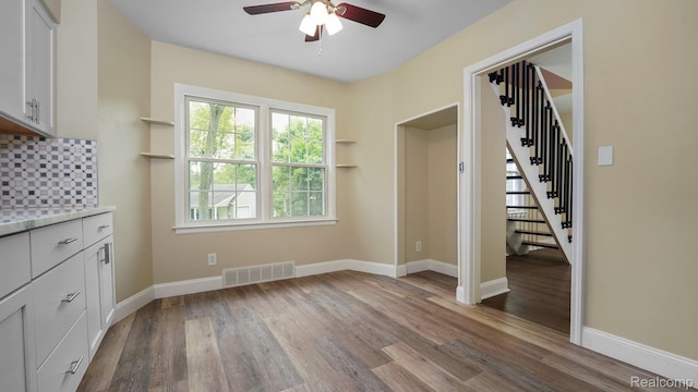 1139 S 7th St, Ann Arbor, MI 48103 - unfurnished dining area featuring a ceiling fan, stairway, and wood finished floors