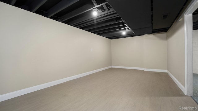1139 S 7th St, Ann Arbor, MI 48103 - finished basement featuring light wood-style flooring and baseboards