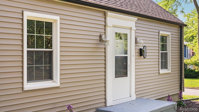 1139 S 7th St, Ann Arbor, MI 48103 - view of exterior entry with roof with shingles