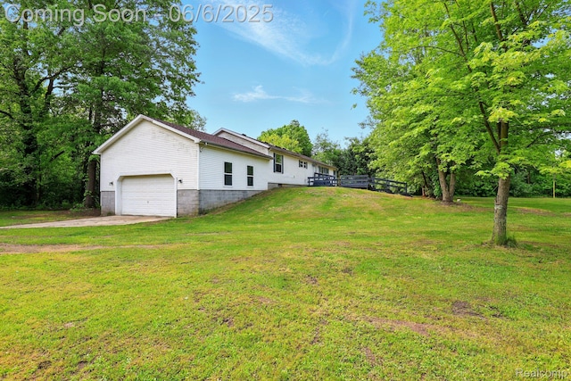 10900 Tuttlehill Rd, Milan, MI 48160 - view of grassy yard with concrete driveway and an attached garage