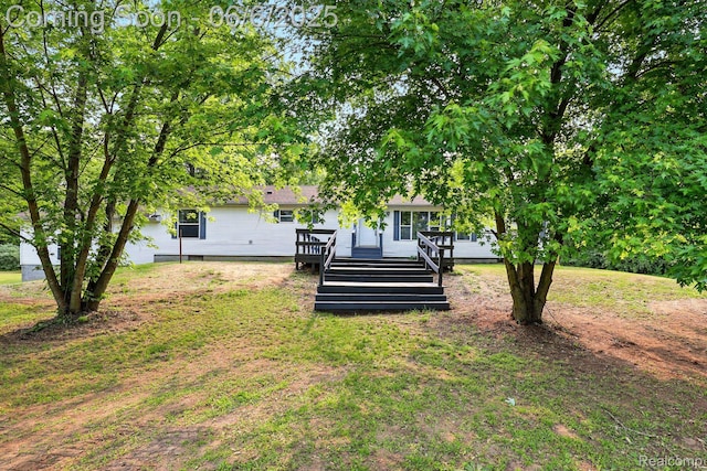 10900 Tuttlehill Rd, Milan, MI 48160 - view of grassy yard featuring a wooden deck