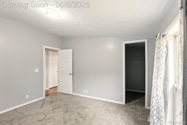 10900 Tuttlehill Rd, Milan, MI 48160 - unfurnished bedroom featuring carpet floors, a spacious closet, baseboards, a textured ceiling, and a closet