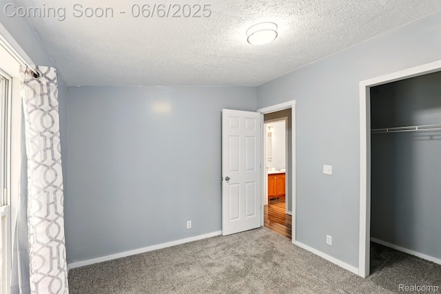 10900 Tuttlehill Rd, Milan, MI 48160 - unfurnished bedroom with a closet, carpet floors, baseboards, and a textured ceiling