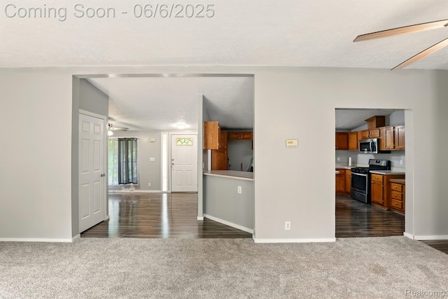 10900 Tuttlehill Rd, Milan, MI 48160 - unfurnished living room featuring dark colored carpet, baseboards, and dark wood-style floors