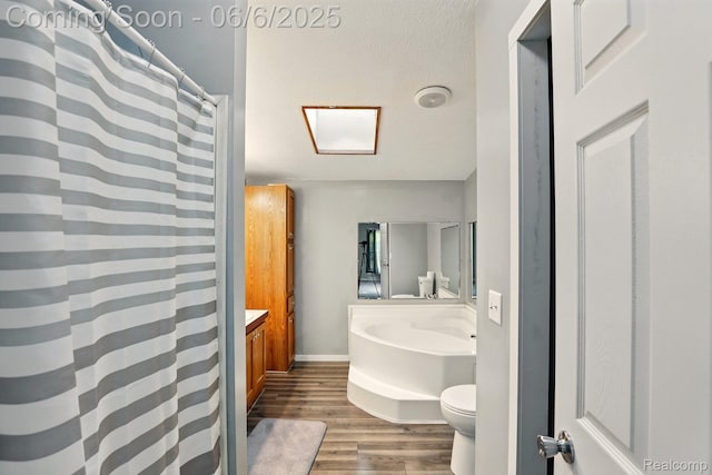 10900 Tuttlehill Rd, Milan, MI 48160 - full bath featuring vanity, toilet, wood finished floors, baseboards, and a shower with shower curtain