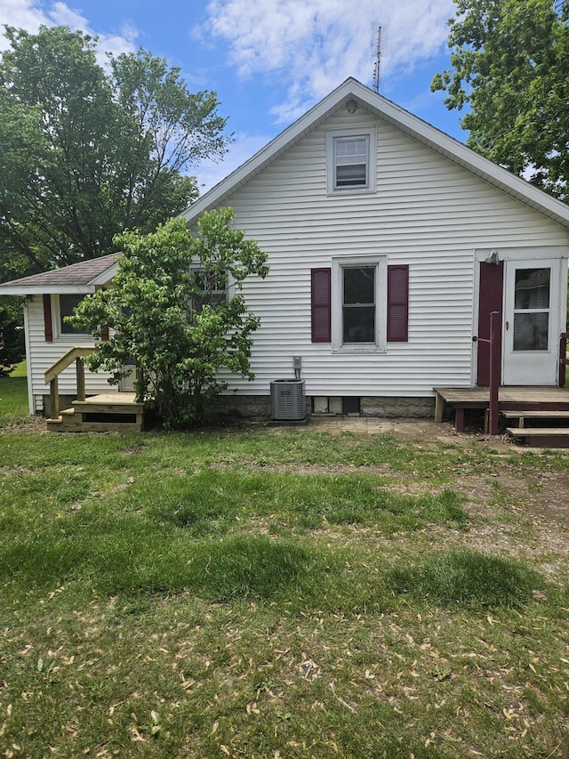 2745 Riverside Rd, Benton Harbor, MI 49022 - rear view of property featuring a wooden deck, cooling unit, and a yard