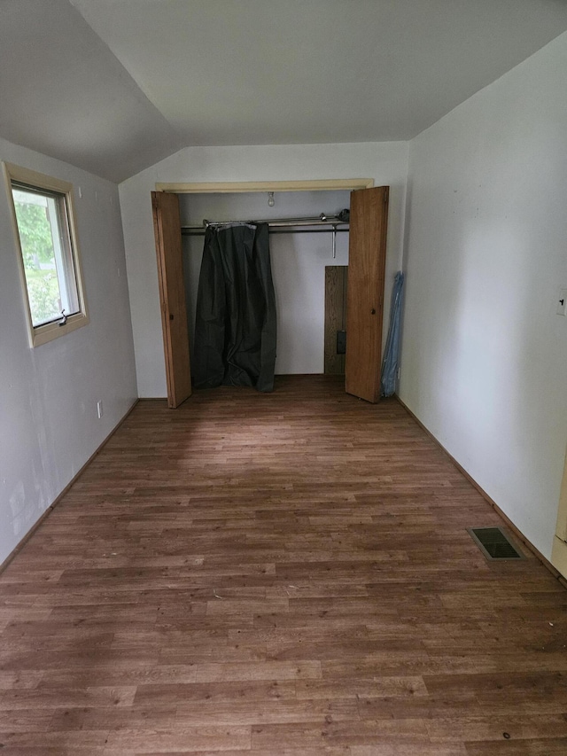 2745 Riverside Rd, Benton Harbor, MI 49022 - unfurnished bedroom featuring vaulted ceiling and wood finished floors