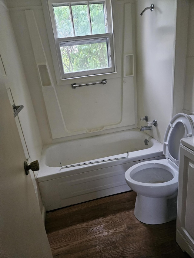 2745 Riverside Rd, Benton Harbor, MI 49022 - bathroom featuring toilet, washtub / shower combination, wood finished floors, and vanity