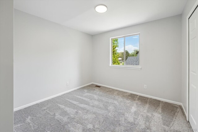 1011 Knowles St, Royal Oak, MI 48067 - unfurnished bedroom featuring carpet floors, baseboards, and a closet