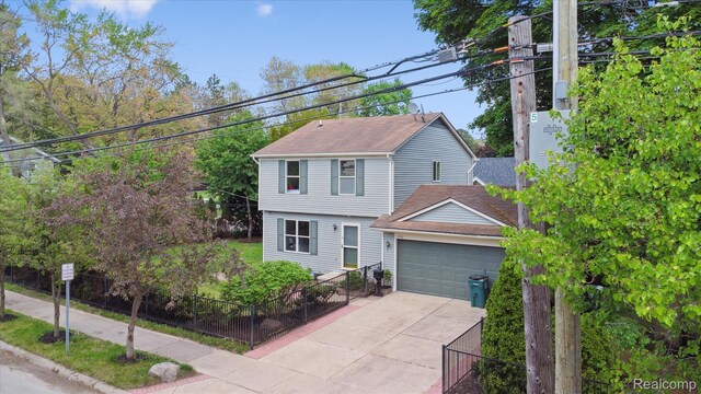 1011 Knowles St, Royal Oak, MI 48067 - colonial-style house featuring concrete driveway, a garage, and a shingled roof