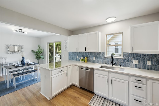 1011 Knowles St, Royal Oak, MI 48067 - kitchen with stainless steel dishwasher, a sink, a peninsula, white cabinets, and light wood finished floors