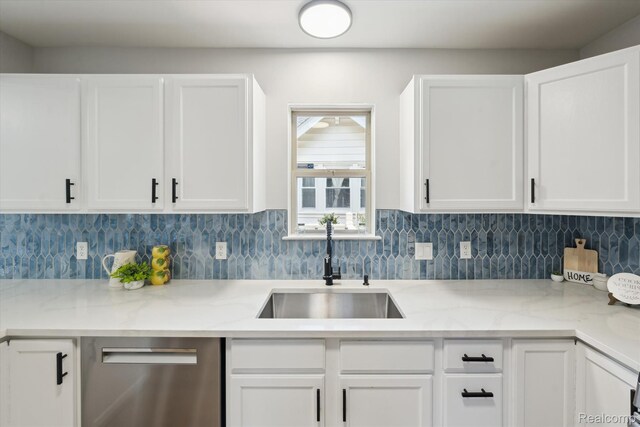 1011 Knowles St, Royal Oak, MI 48067 - kitchen with dishwasher, a sink, white cabinets, and decorative backsplash