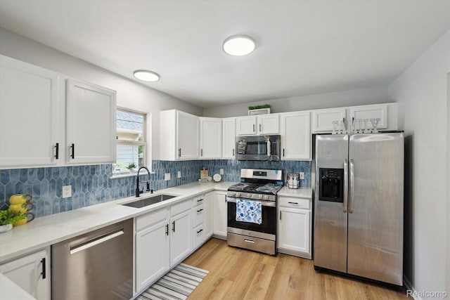 1011 Knowles St, Royal Oak, MI 48067 - kitchen with stainless steel appliances, a sink, and white cabinets