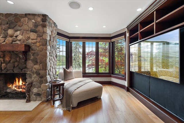 490 E Long Lake Rd, Bloomfield Hills, MI 48304 - sitting room featuring light wood-style flooring, healthy amount of natural light, a stone fireplace, and recessed lighting
