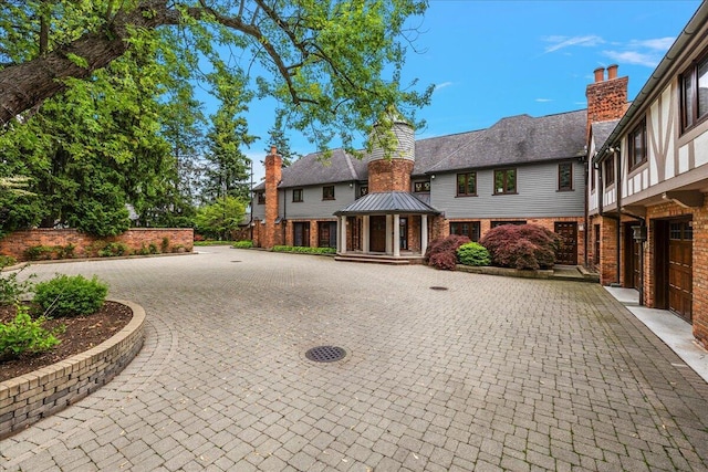 490 E Long Lake Rd, Bloomfield Hills, MI 48304 - view of front of property with brick siding, a chimney, and a gazebo