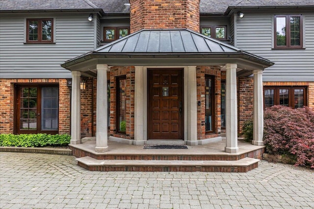 490 E Long Lake Rd, Bloomfield Hills, MI 48304 - entrance to property with brick siding, a standing seam roof, and metal roof