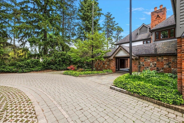 490 E Long Lake Rd, Bloomfield Hills, MI 48304 - exterior space with a chimney, a high end roof, and brick siding