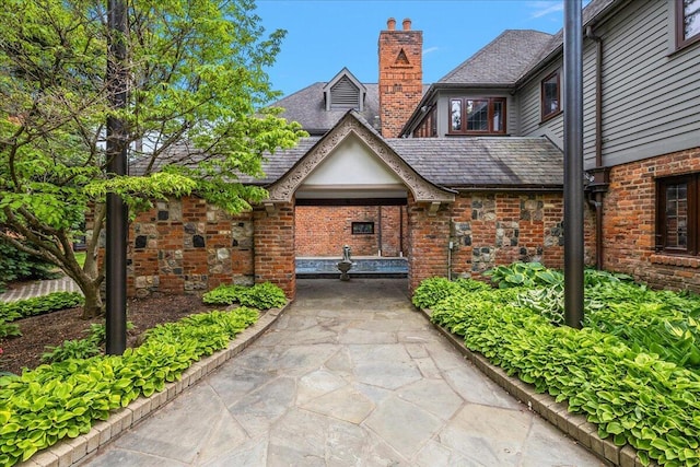 490 E Long Lake Rd, Bloomfield Hills, MI 48304 - view of exterior entry featuring a chimney and brick siding