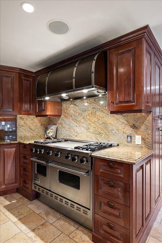 490 E Long Lake Rd, Bloomfield Hills, MI 48304 - kitchen featuring range with two ovens, ventilation hood, tasteful backsplash, light stone counters, and stone tile flooring