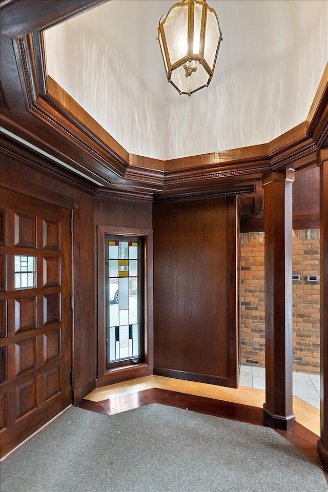 490 E Long Lake Rd, Bloomfield Hills, MI 48304 - foyer entrance featuring ornate columns, a chandelier, ornamental molding, and wood walls