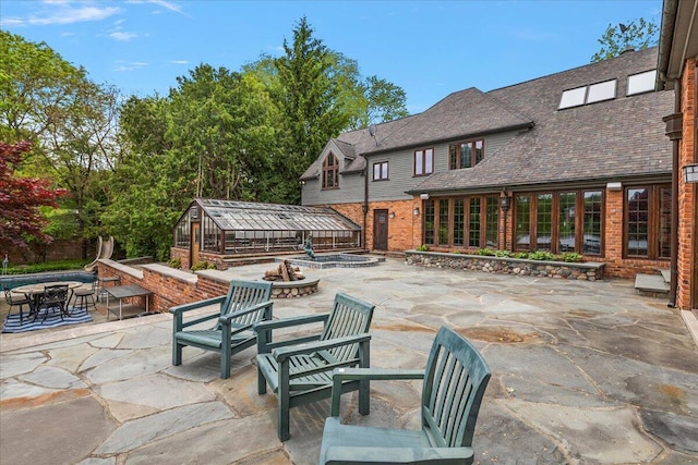 490 E Long Lake Rd, Bloomfield Hills, MI 48304 - view of patio / terrace with a fire pit, a greenhouse, and an outdoor structure