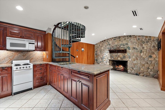 490 E Long Lake Rd, Bloomfield Hills, MI 48304 - kitchen with white appliances, a peninsula, lofted ceiling, open floor plan, and a stone fireplace