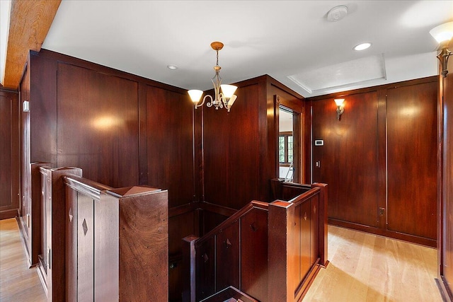 490 E Long Lake Rd, Bloomfield Hills, MI 48304 - hallway featuring an upstairs landing, light wood-type flooring, a chandelier, recessed lighting, and wooden walls