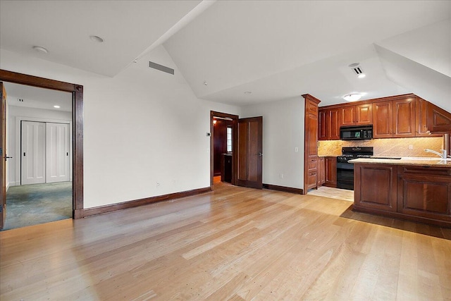 490 E Long Lake Rd, Bloomfield Hills, MI 48304 - kitchen featuring black appliances, vaulted ceiling, light countertops, decorative backsplash, and baseboards
